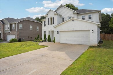 Traditional home with brick siding, driveway, and an attached garage