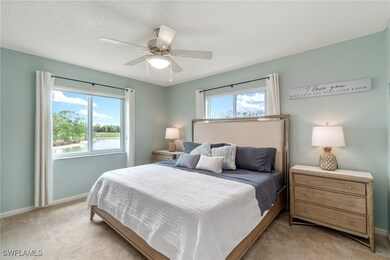 Bedroom with baseboards, light carpet, and ceiling