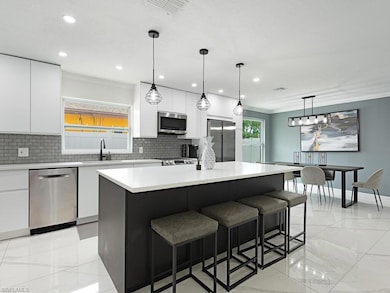 Kitchen with a center island, hanging light fixtur