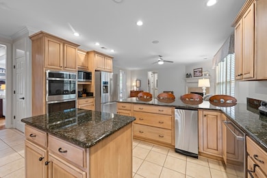 The gourmet kitchen is a chef's dream, equipped with granite countertops, stainless steel appliances, and a central island.