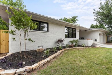 View of front of property featuring crawl space, an attached garage, a front lawn, and brick siding