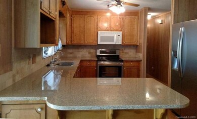 Kitchen with large serving area and granite counte