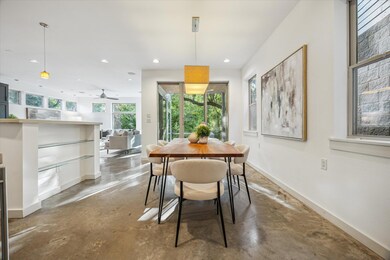 Dining room with concrete flooring, baseboards, a