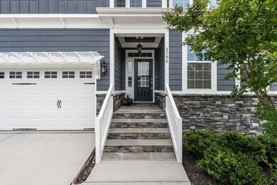 Stone wrapped stairs covered porch.