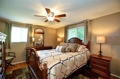Master bedroom with hardwood floors and master bat
