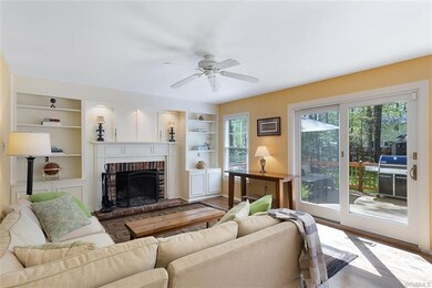 Living room with fireplace, built-ins, and sliding