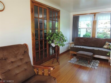 French doors open from the living room to the fami