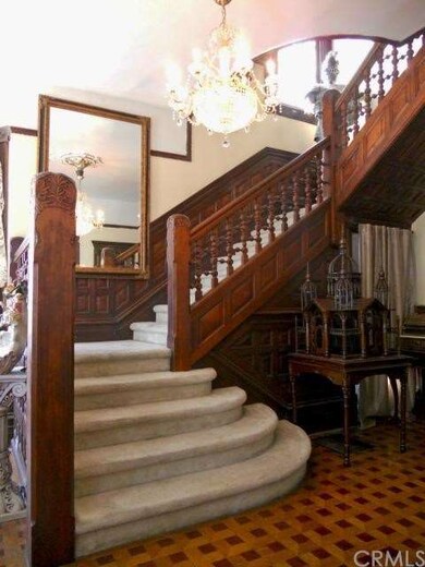 Original carved wood staircase in the foyer.