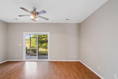 Empty room with ceiling fan and hardwood / wood-st