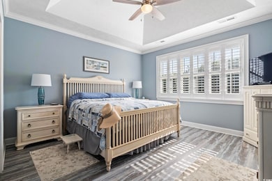 Bedroom with crown molding, dark hardwood / wood-s