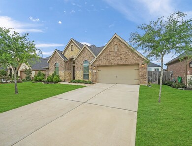 Double wide driveway and three car tandem garage offers plenty of parking and storage space.