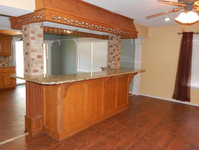 Kitchen featuring dark wood-style floors, tasteful