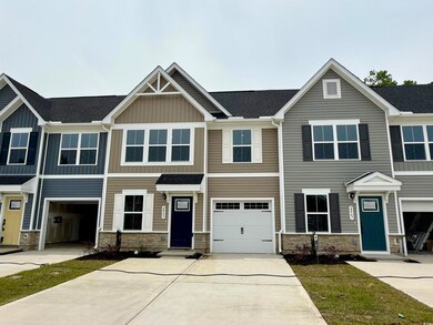 View of front of house featuring stone siding, driveway, a shingled roof, and board and batten siding