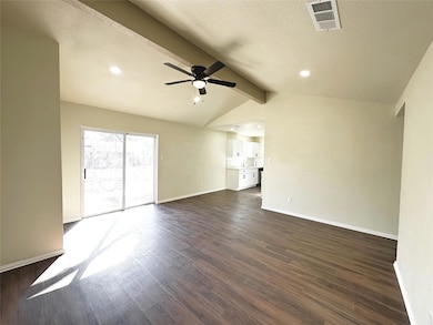 Unfurnished living room with dark wood-type floori