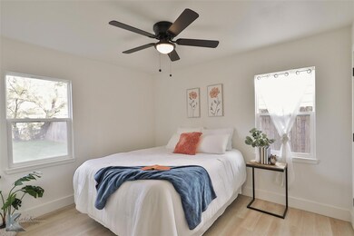 Bedroom featuring ceiling fan and light wood-type 