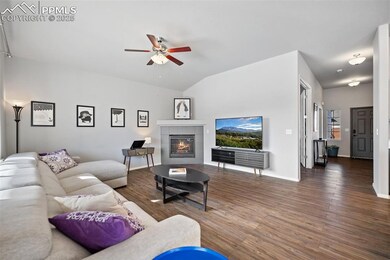 Living room featuring lofted ceiling, gas fireplac