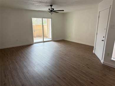 Spare room featuring baseboards, a textured ceilin