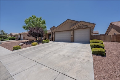 Single story home with a garage, driveway, and stu