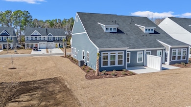 Rear view of house with roof with shingles, a pati