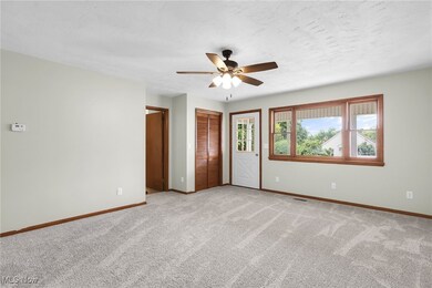 Unfurnished room with light carpet and a ceiling fan