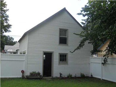 View of garage showing second level window above f