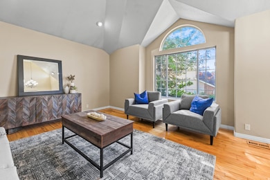 Living area with light wood finished floors and lofted ceiling