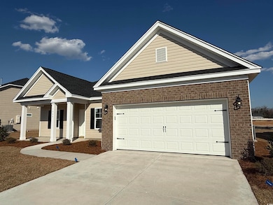 View of front of home featuring a garage, covered 