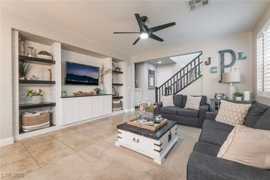 Living area with a ceiling fan, stairway, built in