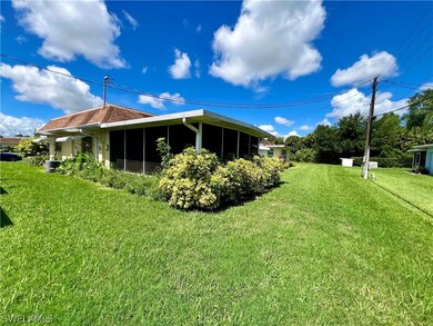 View of side of home with a yard and central air c
