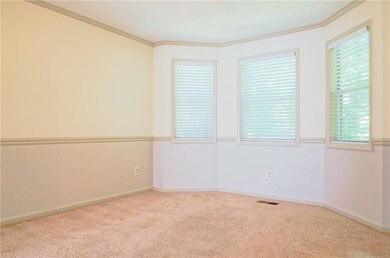 Unfurnished room with carpet floors, ornamental molding, and baseboards