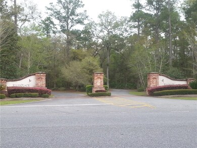 A very nice entrance winds down a shaded drive to