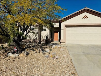 Single story home with concrete driveway, stucco siding, an attached garage, and a tile roof