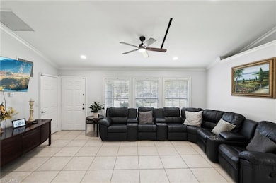 Living room featuring crown molding, ceiling fan, 