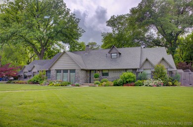 View of front of house with a front yard, stone si