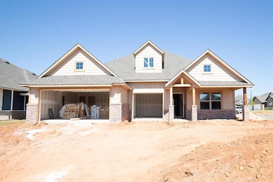 Craftsman house with a shingled roof, a garage, covered porch, and brick siding