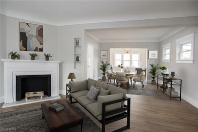 Living room with an inviting chandelier and wood-type flooring