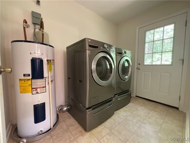 Laundry area with water heater and independent washer and dryer