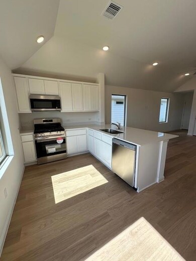 Kitchen featuring range, dishwashing machine, a p