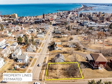 Birds eye view of property with a water view and a view of city
