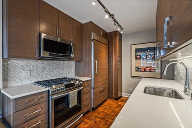 Kitchen featuring a sink, light countertops, backsplash, and stainless steel appliances
