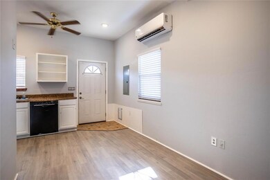 Kitchen with ceiling fan, a wall unit AC, white ca