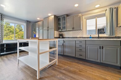 Kitchen with backsplash, wood-type flooring, and g