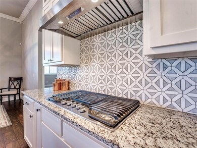 Kitchen:  Granite counters, wood flooring, pendant