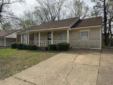 Ranch-style house featuring a porch and a front lawn