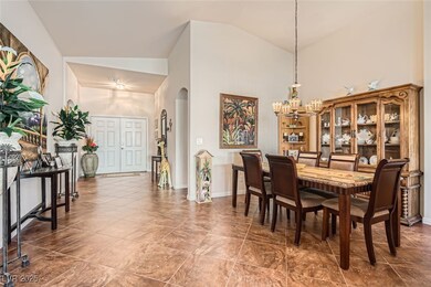 Dining room with high vaulted ceiling, baseboards,