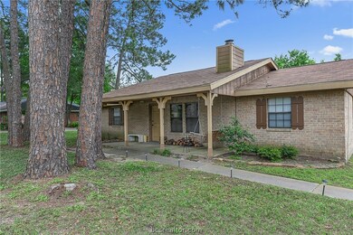 Front covered porch nicely shaded by large pine tr