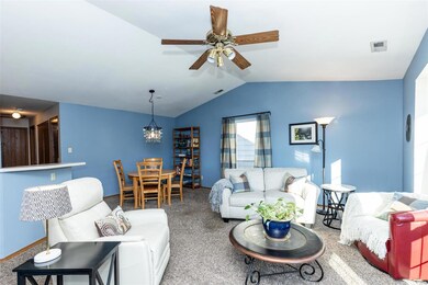 Vaulted ceiling with ceiling fan.