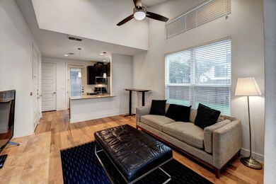 Living area featuring ceiling fan, light wood-typ