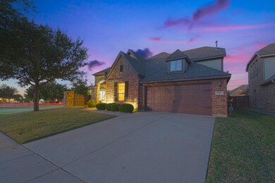 View of front of property featuring a lawn and a g