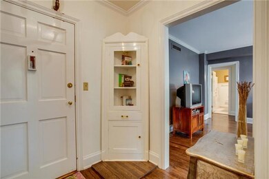 Charming built-in corner cabinet in entry.